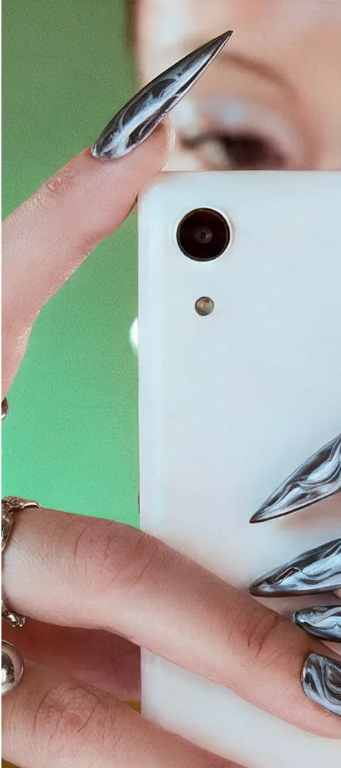 Back of the white Caytonia Phone in front of a green background