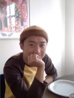 Sample photo: smiling person with beanie at a table